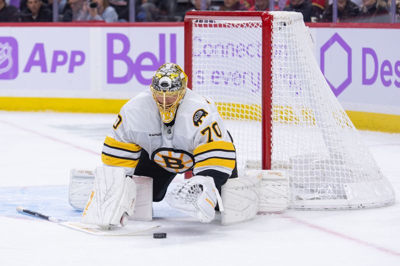 Nov 13, 2025; Ottawa, Ontario, CAN; Boston Bruins goalie Joonas Korpisalo (70) covers the puck following a save in the first period against the Ottawa Senators at the Canadian Tire Centre. Mandatory Credit: Marc DesRosiers-IMAGN Images
