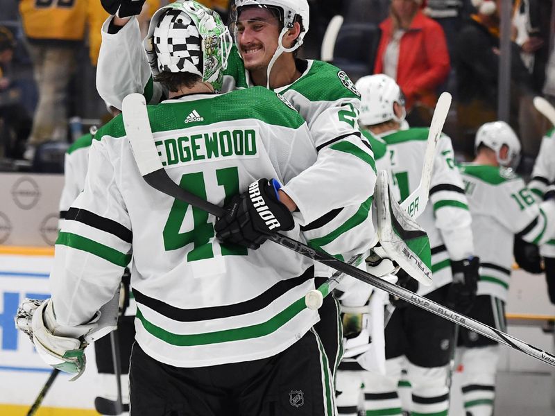 Dec 23, 2023; Nashville, Tennessee, USA; Dallas Stars left wing Mason Marchment (27) and goaltender Scott Wedgewood (41) celebrate after a win against the Nashville Predators at Bridgestone Arena. Mandatory Credit: Christopher Hanewinckel-USA TODAY Sports