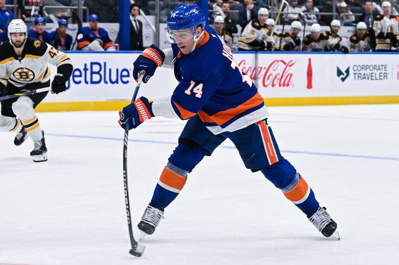 Nov 27, 2024; Elmont, New York, USA;  New York Islanders center Bo Horvat (14) attempts a shot against the Boston Bruins during the second period at UBS Arena. Mandatory Credit: Dennis Schneidler-Imagn Images