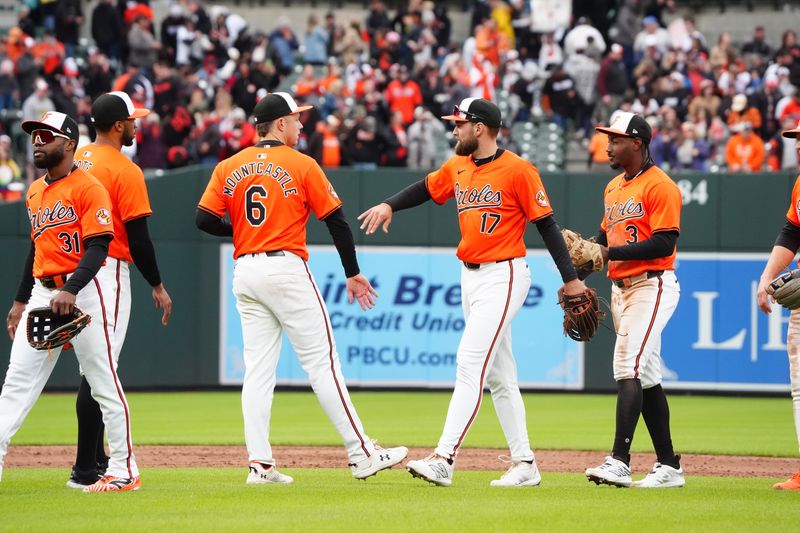 Apr 27, 2024; Baltimore, Maryland, USA;  Baltimore Orioles first baseman Ryan Mountcastle (6) and left fielder Colton Cowser (17) low five to celebrate the victory after the ninth inning against the Oakland Athletics  at Oriole Park at Camden Yards. Mandatory Credit: Gregory Fisher-USA TODAY Sports