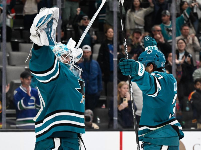 Nov 28, 2025; San Jose, California, USA; San Jose Sharks goaltender Yaroslav Askarov (30) and defenseman Timothy Liljegren (37) celebrate after the game against the Vancouver Canucks at SAP Center at San Jose. Mandatory Credit: Eakin Howard-Imagn Images