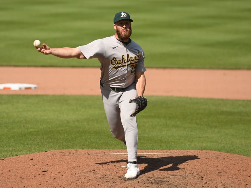 Apr 28, 2024; Baltimore, Maryland, USA;  Oakland Athletics relief pitcher Austin Adams (29) delivers a pitch during the seventh inning against the Baltimore Orioles at Oriole Park at Camden Yards. Mandatory Credit: James A. Pittman-USA TODAY Sports