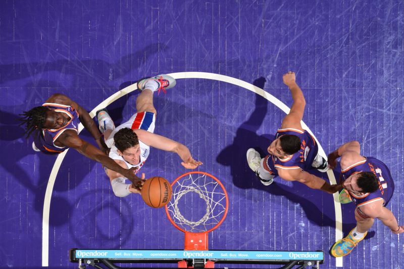 PHOENIX, AZ - FEBRUARY 14:  Bol Bol #11 of the Phoenix Suns plays defense against Mike Muscala #41 of the Detroit Pistons on February 14, 2024 at Footprint Center in Phoenix, Arizona. NOTE TO USER: User expressly acknowledges and agrees that, by downloading and or using this photograph, user is consenting to the terms and conditions of the Getty Images License Agreement. Mandatory Copyright Notice: Copyright 2024 NBAE (Photo by Barry Gossage/NBAE via Getty Images)