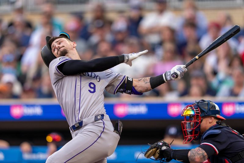 Jun 10, 2024; Minneapolis, Minnesota, USA; Colorado Rockies center fielder Brenton Doyle (9) swings and loses his helmet against the Minnesota Twins in the fourth inning at Target Field. Mandatory Credit: Jesse Johnson-USA TODAY Sports