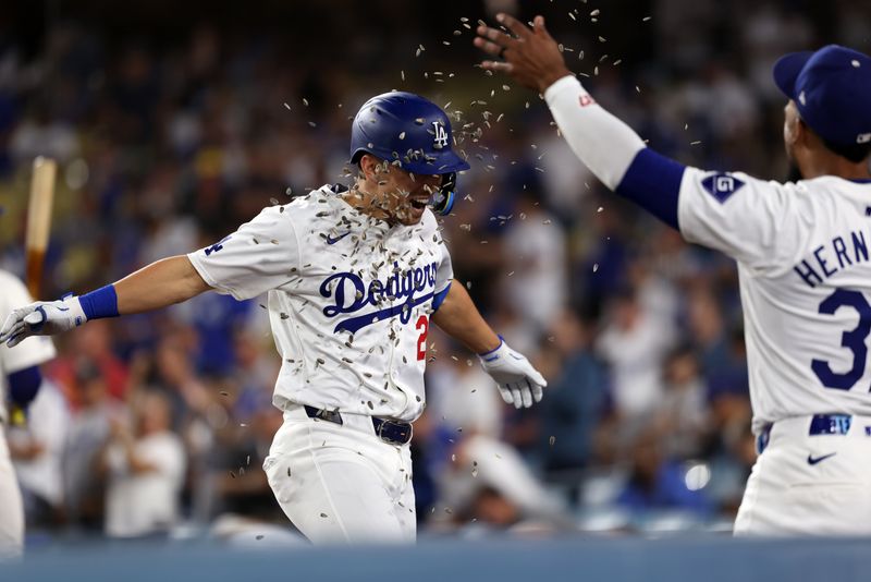 Sep 10, 2024; Los Angeles, California, USA;  Los Angeles Dodgers center fielder Tommy Edman (25) celebrates his solo home run with out fielder Teoscar Hernandez (37) during the second inning against the Chicago Cubs at Dodger Stadium. Mandatory Credit: Kiyoshi Mio-Imagn Images