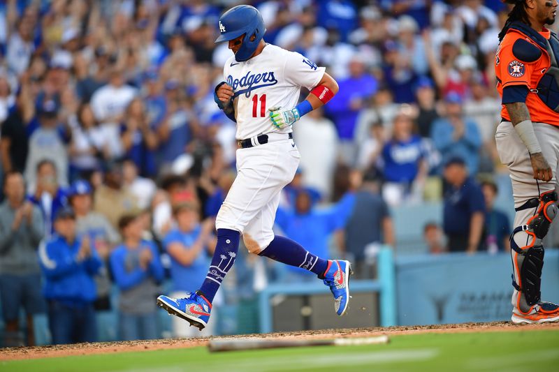 Jun 25, 2023; Los Angeles, California, USA; Los Angeles Dodgers shortstop Miguel Rojas (11) scores a run against the Houston Astros during the tenth inning at Dodger Stadium. Mandatory Credit: Gary A. Vasquez-USA TODAY Sports