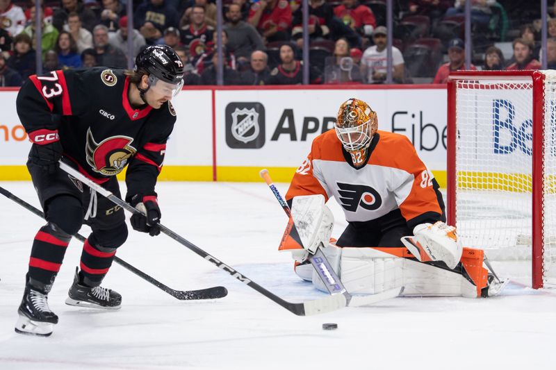 Nov 14, 2024; Ottawa, Ontario, CAN; Ottawa Senators left wing Noah Gregor (73) shoots on Philadelphia Flyers goalie Ivan Fedotov (82) in the first period at the Canadian Tire Centre. Mandatory Credit: Marc DesRosiers-Imagn Images