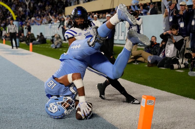 Nov 11, 2023; Chapel Hill, North Carolina, USA; North Carolina Tar Heels tight end Bryson Nesbit (18) catches a touchdown pass as Duke Blue Devils nickel Brandon Johnson (3) defends in the fourth quarter at Kenan Memorial Stadium. Mandatory Credit: Bob Donnan-USA TODAY Sports