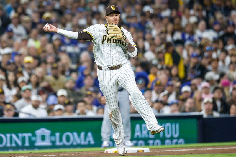 Jun 9, 2025; San Diego, California, USA; San Diego Padres third baseman Manny Machado (13) throws to first for an out during the sixth inning against the Los Angeles Dodgers at Petco Park. Mandatory Credit: David Frerker-Imagn Images