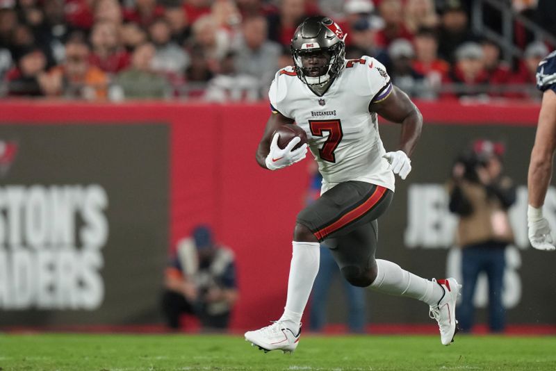 Tampa Bay Buccaneers running back Leonard Fournette (7) rushes with the ball during a wild card NFL football playoff game against the Dallas Cowboys, Monday, Jan. 16, 2023, in Tampa, Fla. (AP Photo/Peter Joneleit)