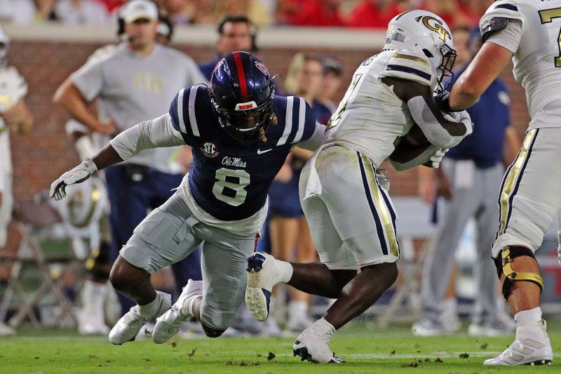 Sep 16, 2023; Oxford, Mississippi, USA;  Mississippi Rebels linebacker Monty Montgomery (8) tackles Georgia Tech Yellow Jackets running back Jamal Haynes (11) during the first half at Vaught-Hemingway Stadium. Mandatory Credit: Petre Thomas-USA TODAY Sports