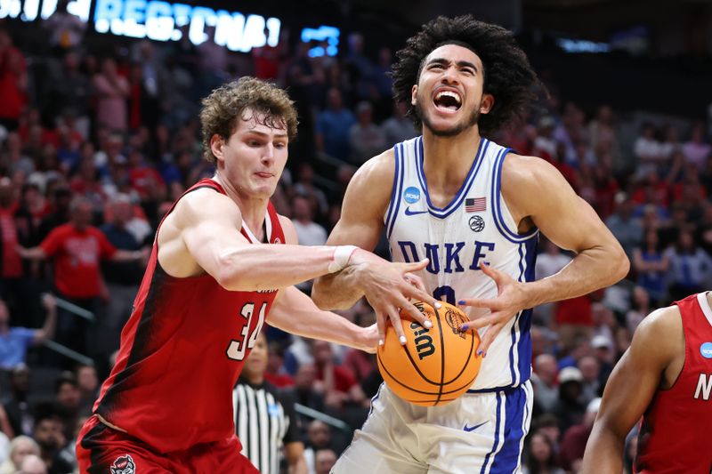 Mar 31, 2024; Dallas, TX, USA; Duke Blue Devils guard Jared McCain (0) loses control of the ball against North Carolina State Wolfpack forward Ben Middlebrooks (34) in the second half in the finals of the South Regional of the 2024 NCAA Tournament at American Airline Center. Mandatory Credit: Tim Heitman-USA TODAY Sports