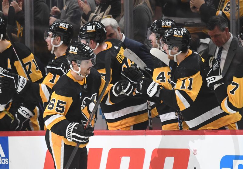 Nov 25, 2023; Pittsburgh, Pennsylvania, USA; Pittsburgh Penguins defenseman Erik Karlsson (65) is greeted after scoring against the Toronto Maple Leafs during the second period at PPG Paints Arena. Mandatory Credit: Philip G. Pavely-USA TODAY Sports