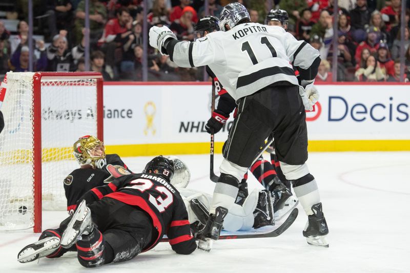 Nov 2, 2023; Ottawa, Ontario, CAN; Los Angeles Kings center Anze Kopitar (11) scores against Ottawa Senators goalie Joonas Korpisalo (70) in the second period at the Canadian Tire Centre. Mandatory Credit: Marc DesRosiers-USA TODAY Sports