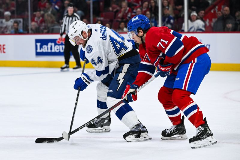 Apr 4, 2024; Montreal, Quebec, CAN; Tampa Bay Lightning defenseman Calvin De Haan (44) defends the puck against Montreal Canadiens center Jake Evans (71) during the third period at Bell Centre. Mandatory Credit: David Kirouac-USA TODAY Sports