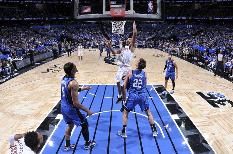 ORLANDO, FL - APRIL 27: Evan Mobley #4 of the Cleveland Cavaliers drives to the basket during the game against the Orlando Magic during Round 1 Game 4 of the 2024 NBA Playoffs on April 27, 2024 at the Kia Center in Orlando, Florida. NOTE TO USER: User expressly acknowledges and agrees that, by downloading and or using this photograph, User is consenting to the terms and conditions of the Getty Images License Agreement. Mandatory Copyright Notice: Copyright 2024 NBAE (Photo by Fernando Medina/NBAE via Getty Images)