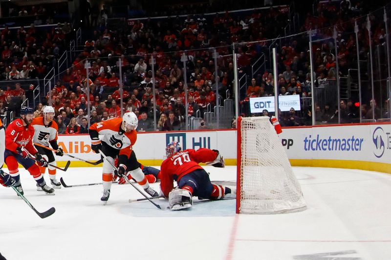 Mar 1, 2024; Washington, District of Columbia, USA; Washington Capitals goaltender Charlie Lindgren (79) makes a save on Philadelphia Flyers center Sean Couturier (14) in the third period at Capital One Arena. Mandatory Credit: Geoff Burke-USA TODAY Sports