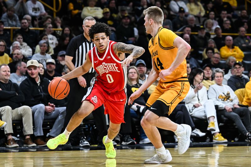 Feb 25, 2026; Iowa City, Iowa, USA; Ohio State Buckeyes guard John Mobley Jr. (0) controls the ball as Iowa Hawkeyes guard Bennett Stirtz (14) defends during the first half at Carver-Hawkeye Arena. Mandatory Credit: Jeffrey Becker-Imagn Images