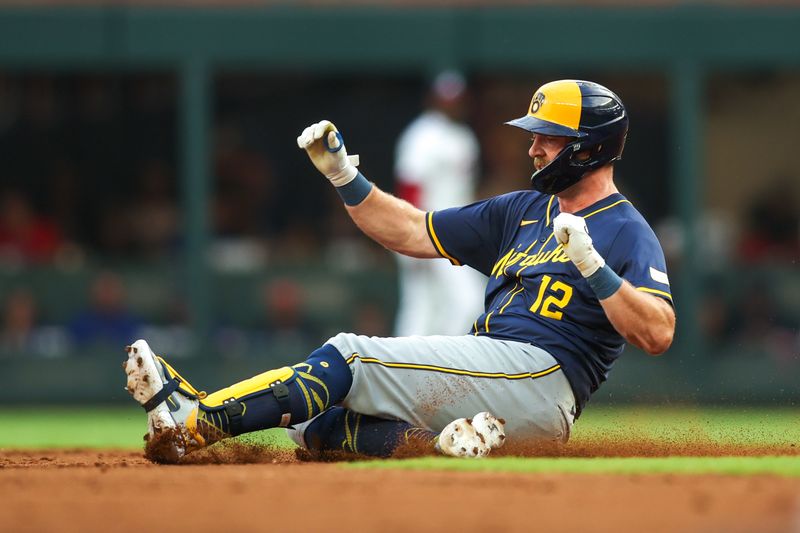 Aug 6, 2024; Atlanta, Georgia, USA; Milwaukee Brewers designated hitter Rhys Hoskins (12) slides in safely with a double against the Atlanta Braves in the second inning at Truist Park. Mandatory Credit: Brett Davis-USA TODAY Sports