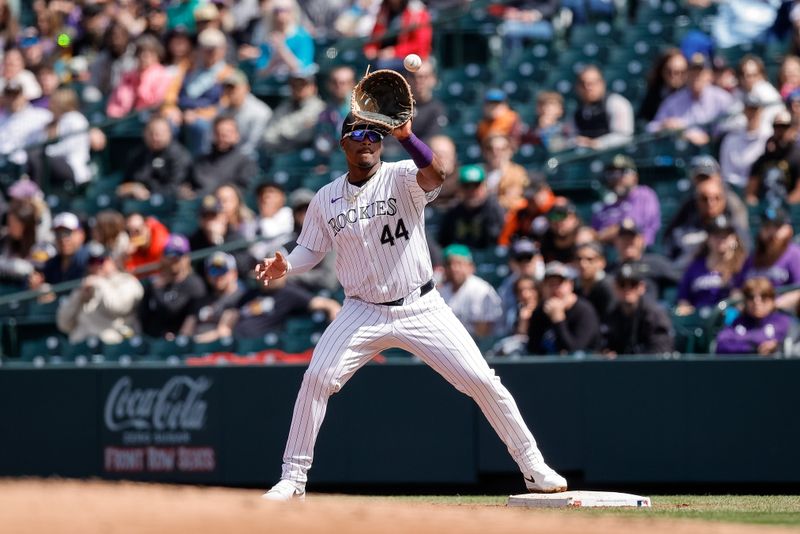 Apr 10, 2024; Denver, Colorado, USA; Colorado Rockies first baseman Elehuris Montero (44) fields a throw to first for an out in the second inning against the Arizona Diamondbacks at Coors Field. Mandatory Credit: Isaiah J. Downing-USA TODAY Sports