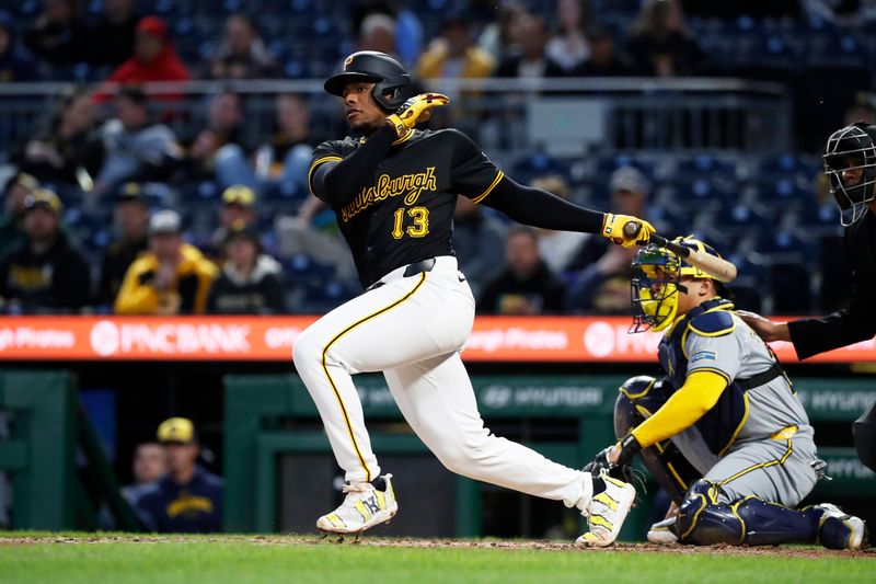 Apr 22, 2024; Pittsburgh, Pennsylvania, USA;  Pittsburgh Pirates third baseman Ke'Bryan Hayes (13) hits a single against the Milwaukee Brewers during the sixth inning at PNC Park. Mandatory Credit: Charles LeClaire-USA TODAY Sports