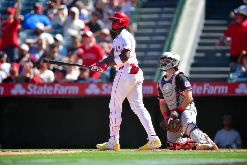 Apr 6, 2025; Anaheim, California, USA; Los Angeles Angels right fielder Jorge Soler (12) hits a sacrifice RBI against the Cleveland Guardians during the seventh inning at Angel Stadium. Mandatory Credit: Gary A. Vasquez-Imagn Images