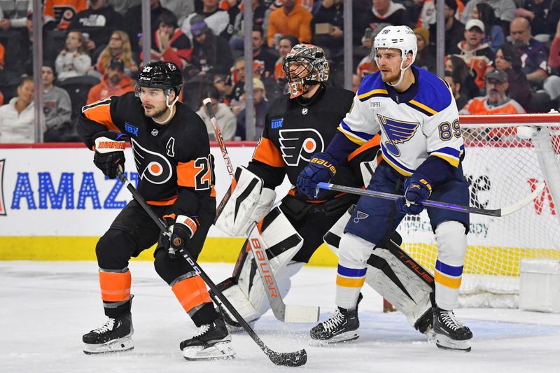 Mar 4, 2024; Philadelphia, Pennsylvania, USA; Philadelphia Flyers center Scott Laughton (21) and goaltender Samuel Ersson (33) battle for position with St. Louis Blues left wing Pavel Buchnevich (89) during the first period at Wells Fargo Center. Mandatory Credit: Eric Hartline-USA TODAY Sports