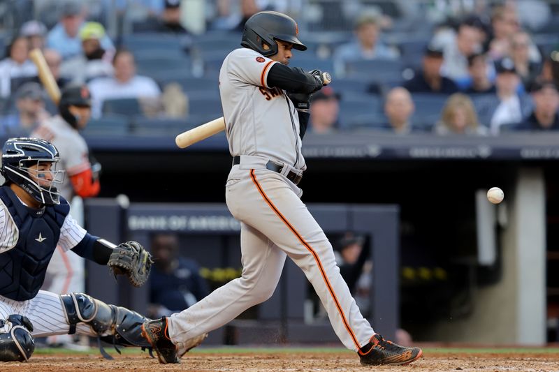 Apr 1, 2023; Bronx, New York, USA; San Francisco Giants first baseman LaMonte Wade Jr. (31) hits a check swing RBI infield single against the New York Yankees during the sixth inning at Yankee Stadium. Mandatory Credit: Brad Penner-USA TODAY Sports