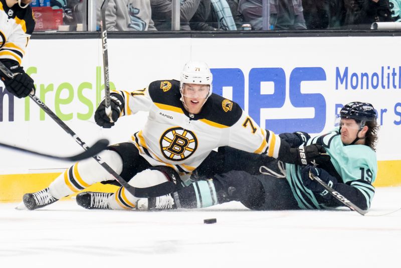 Feb 23, 2023; Seattle, Washington, USA; Boston Bruins forward Taylor Hall (71) and Seattle Kraken forward Jared McCann (19) battle for the puck during the second period at Climate Pledge Arena. Mandatory Credit: Stephen Brashear-USA TODAY Sports