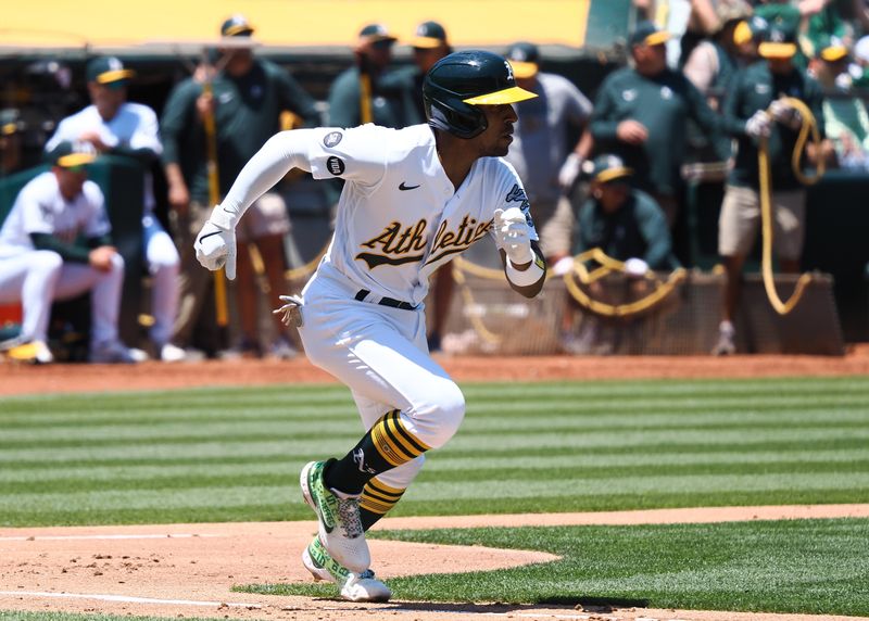 Jun 15, 2023; Oakland, California, USA; Oakland Athletics second baseman Tony Kemp (5) runs for first base on a single during the third inning against the Tampa Bay Rays at Oakland-Alameda County Coliseum. Mandatory Credit: Kelley L Cox-USA TODAY Sports