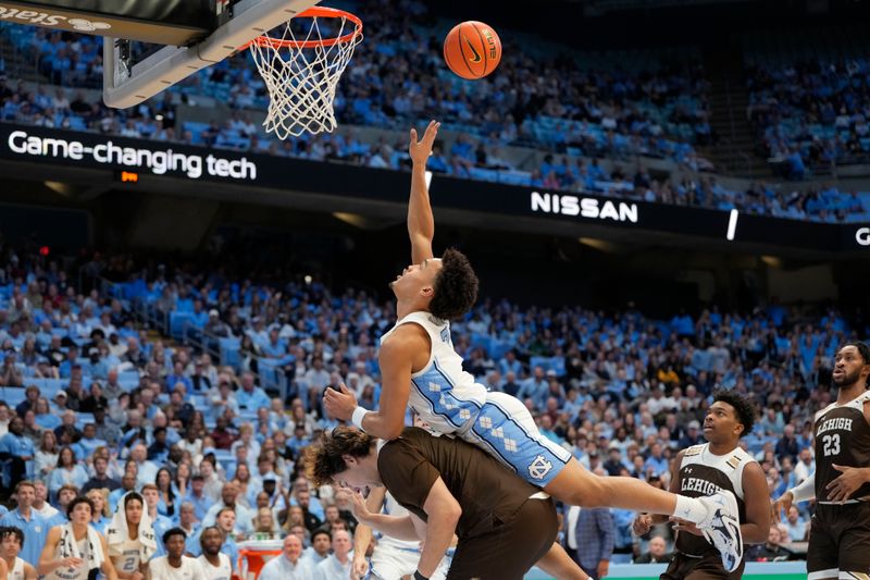 Nov 12, 2023; Chapel Hill, North Carolina, USA; North Carolina Tar Heels guard Seth Trimble (7) shoots as Lehigh Mountain Hawks center JT Tan (42) defends in the second half at Dean E. Smith Center. Mandatory Credit: Bob Donnan-USA TODAY Sports