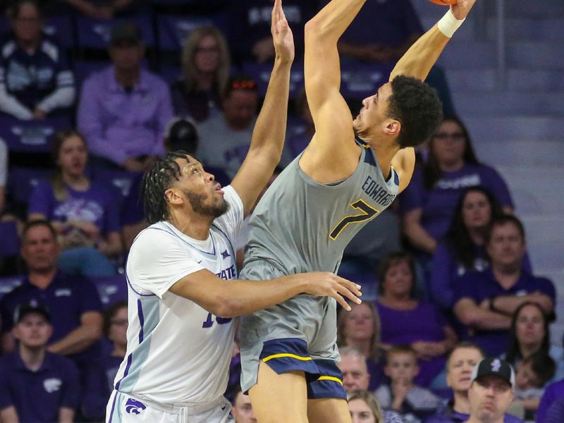 Feb 26, 2024; Manhattan, Kansas, USA; West Virginia Mountaineers center Jesse Edwards (7) shoots against Kansas State Wildcats center Will McNair Jr. (13) during the first half at Bramlage Coliseum. Mandatory Credit: Scott Sewell-USA TODAY Sports