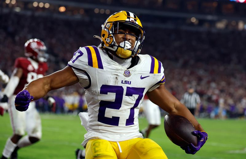 Nov 4, 2023; Tuscaloosa, Alabama, USA; LSU Tigers running back Josh Williams (27) carries the ball in for a touchdown against the Alabama Crimson Tide during the second half at Bryant-Denny Stadium. Mandatory Credit: Butch Dill-USA TODAY Sports