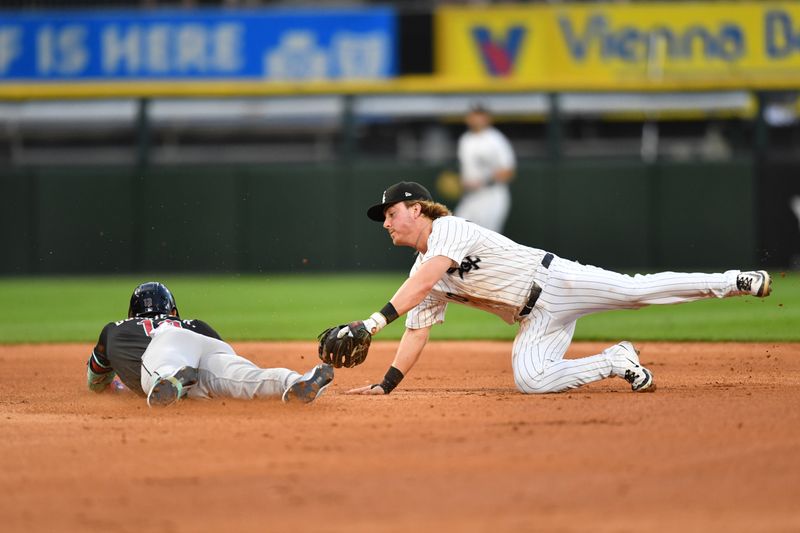 Jun 24, 2025; Chicago, Illinois, USA; Chicago White Sox shortstop Chase Meidroth (10) attempts to tag out Arizona Diamondbacks left fielder Lourdes Gurriel Jr. (12) as he slides into second base for his successful double during the fourth inning at Rate Field. Mandatory Credit: Patrick Gorski-Imagn Images