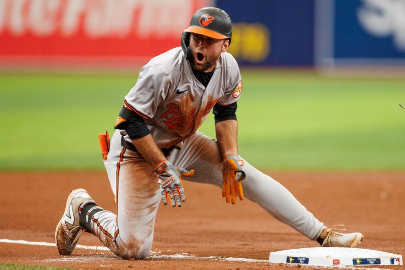 Jun 9, 2024; St. Petersburg, Florida, USA;  Baltimore Orioles outfielder Colton Cowser (17) slides into third base after hitting an rbi triple against the Tampa Bay Rays in the sixth inning at Tropicana Field. Mandatory Credit: Nathan Ray Seebeck-USA TODAY Sports