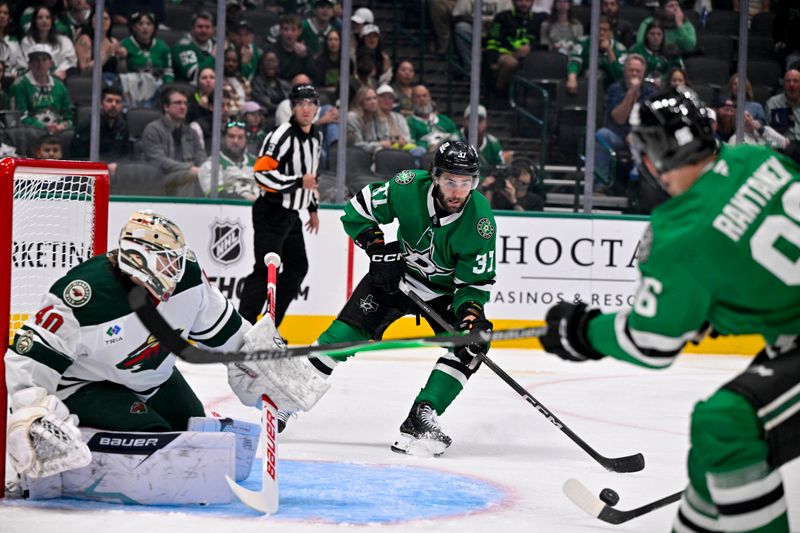 Sep 23, 2025; Dallas, Texas, USA; Dallas Stars right wing Mikko Rantanen (96) passes the puck to center Harrison Scott (37) in front of Minnesota Wild goaltender Cal Petersen (40) during the second period at American Airlines Center. Mandatory Credit: Jerome Miron-Imagn Images