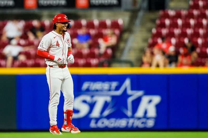 Aug 28, 2024; Cincinnati, Ohio, USA; Cincinnati Reds third baseman Santiago Espinal (4) reacts after hitting a RBI double in the seventh inning against the Oakland Athletics at Great American Ball Park. Mandatory Credit: Katie Stratman-USA TODAY Sports