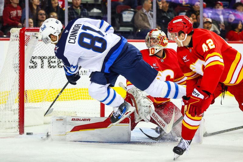 Oct 4, 2024; Calgary, Alberta, CAN; Winnipeg Jets left wing Kyle Connor (81) scores a goal against Calgary Flames goaltender Dan Vladar (80) during the third period at Scotiabank Saddledome. Mandatory Credit: Sergei Belski-Imagn Images