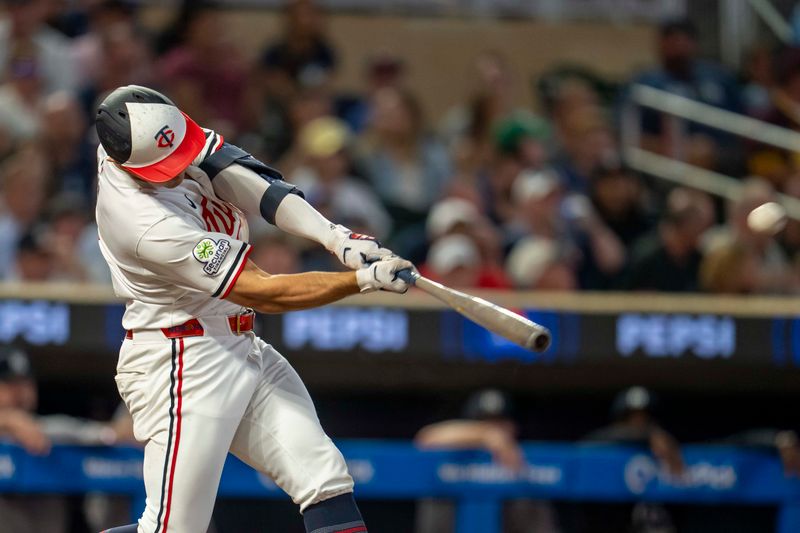 Sep 15, 2025; Minneapolis, Minnesota, USA; Minnesota Twins shortstop Brooks Lee (2) hits a solo home run against the New York Yankees in the fifth inning at Target Field. Mandatory Credit: Jesse Johnson-Imagn Images