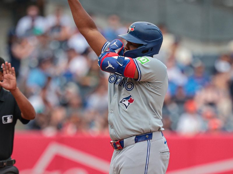 Aug 4, 2024; Bronx, New York, USA; Toronto Blue Jays first baseman Vladimir Guerrero Jr. (27) reacts after hitting a double during the third inning against the New York Yankees at Yankee Stadium. Mandatory Credit: Vincent Carchietta-USA TODAY Sports