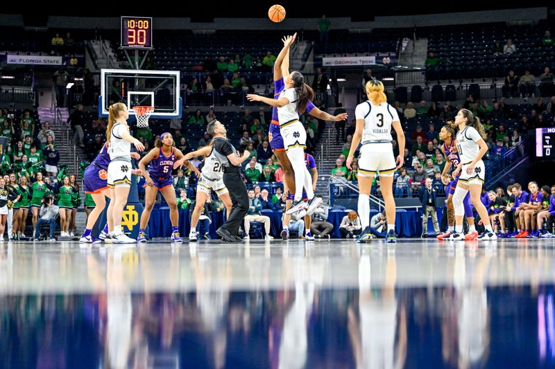 Feb 22, 2024; South Bend, Indiana, USA; Clemson Tigers center Eno Inyang (21) and Notre Dame Fighting Irish forward Kylee Watson (22) jump for the opening tip in the first half at the Purcell Pavilion. Mandatory Credit: Matt Cashore-USA TODAY Sports