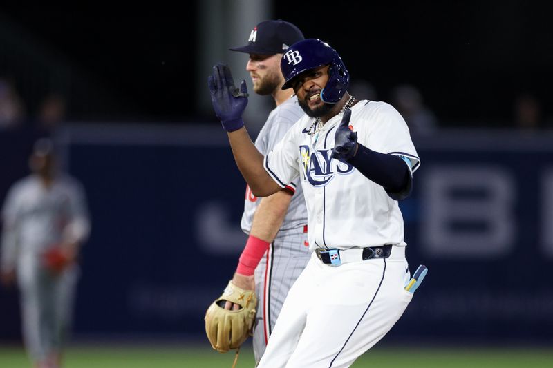 May 26, 2025; Tampa, Florida, USA; Tampa Bay Rays third baseman Junior Caminero (13) doubles against the Minnesota Twins in the sixth inning at George M. Steinbrenner Field. Mandatory Credit: Nathan Ray Seebeck-Imagn Images