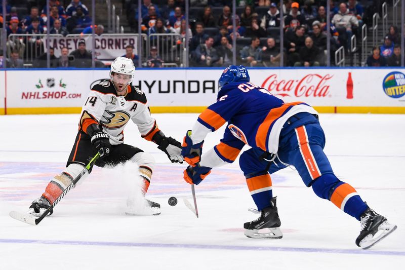 Dec 13, 2023; Elmont, New York, USA; New York Islanders right wing Cal Clutterbuck (15) and Anaheim Ducks center Adam Henrique (14) battle for a loose puck during the third period at UBS Arena. Mandatory Credit: Dennis Schneidler-USA TODAY Sports