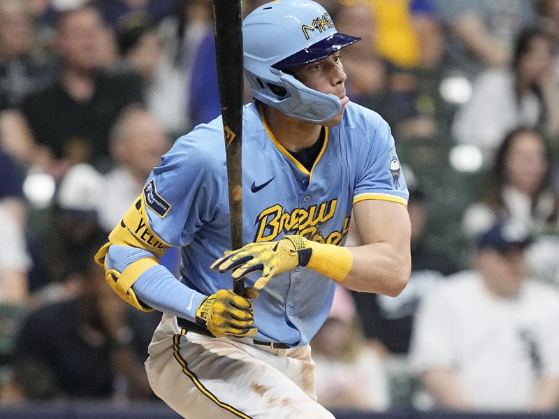 May 31, 2024; Milwaukee, Wisconsin, USA;  Milwaukee Brewers left fielder Christian Yelich (22) hits a two RBI single during the fourth inning against the Chicago White Sox at American Family Field. Mandatory Credit: Jeff Hanisch-USA TODAY Sports