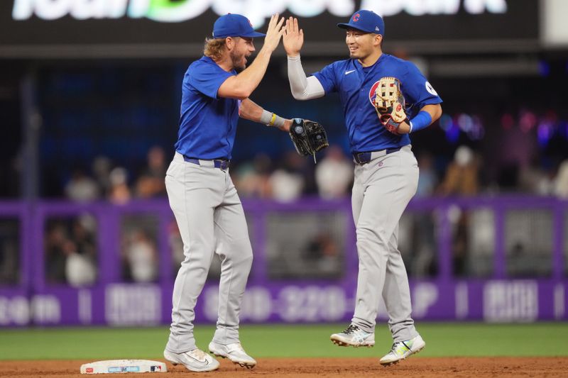 Aug 24, 2024; Miami, Florida, USA;  Chicago Cubs right fielder Seiya Suzuki, right, and first base Patrick Wisdom, left, celebrate a victory against the Miami Marlins at loanDepot Park. Mandatory Credit: Jim Rassol-USA TODAY Sports