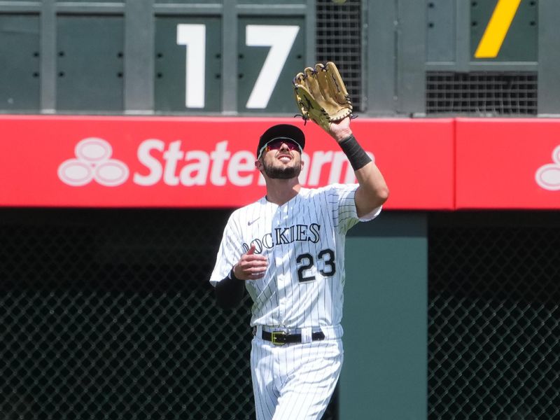 Jul 19, 2023; Denver, Colorado, USA; Colorado Rockies right fielder Kris Bryant (23) fields the ball in the fourth inning against the Houston Astros at Coors Field. Mandatory Credit: Ron Chenoy-USA TODAY Sports