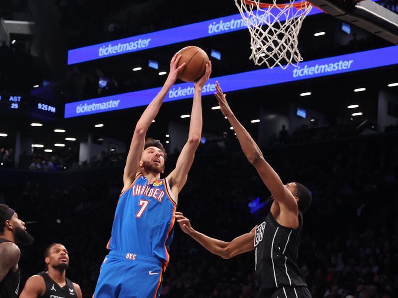 NEW YORK, NEW YORK - JANUARY 05:  Chet Holmgren #7 of the Oklahoma City Thunder shoots against Mikal Bridges #1 of the Brooklyn Nets during their game at Barclays Center on January 05, 2024 in New York City.  User expressly acknowledges and agrees that, by downloading and or using this photograph, User is consenting to the terms and conditions of the Getty Images License Agreement.   (Photo by Al Bello/Getty Images)