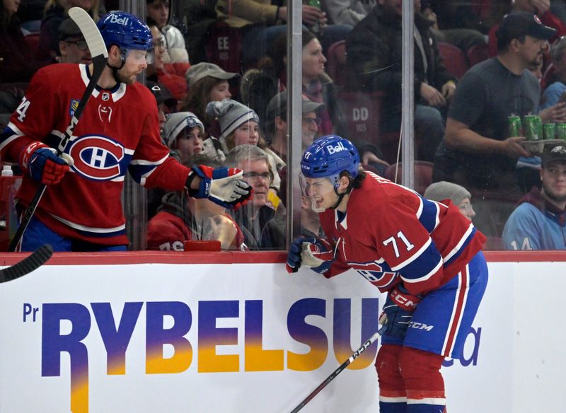 Feb 21, 2024; Montreal, Quebec, CAN; Montreal Canadiens forward Jake Evans (71) heads back to the bench in pain during the second period of the game against the Buffalo Sabres at the Bell Centre. Mandatory Credit: Eric Bolte-USA TODAY Sports