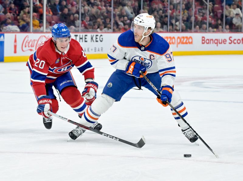 Jan 13, 2024; Montreal, Quebec, CAN; Edmonton Oilers forward Connor McDavid (97) plays the puck and Montreal Canadiens forward Juraj Slafkovsky (20) defends during the first period at the Bell Centre. Mandatory Credit: Eric Bolte-USA TODAY Sports