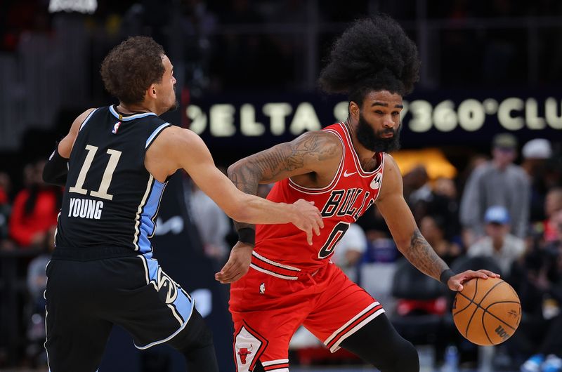 ATLANTA, GEORGIA - FEBRUARY 12:  Coby White #0 of the Chicago Bulls drives against Trae Young #11 of the Atlanta Hawks during the fourth quarter at State Farm Arena on February 12, 2024 in Atlanta, Georgia.  NOTE TO USER: User expressly acknowledges and agrees that, by downloading and/or using this photograph, user is consenting to the terms and conditions of the Getty Images License Agreement.  (Photo by Kevin C. Cox/Getty Images)